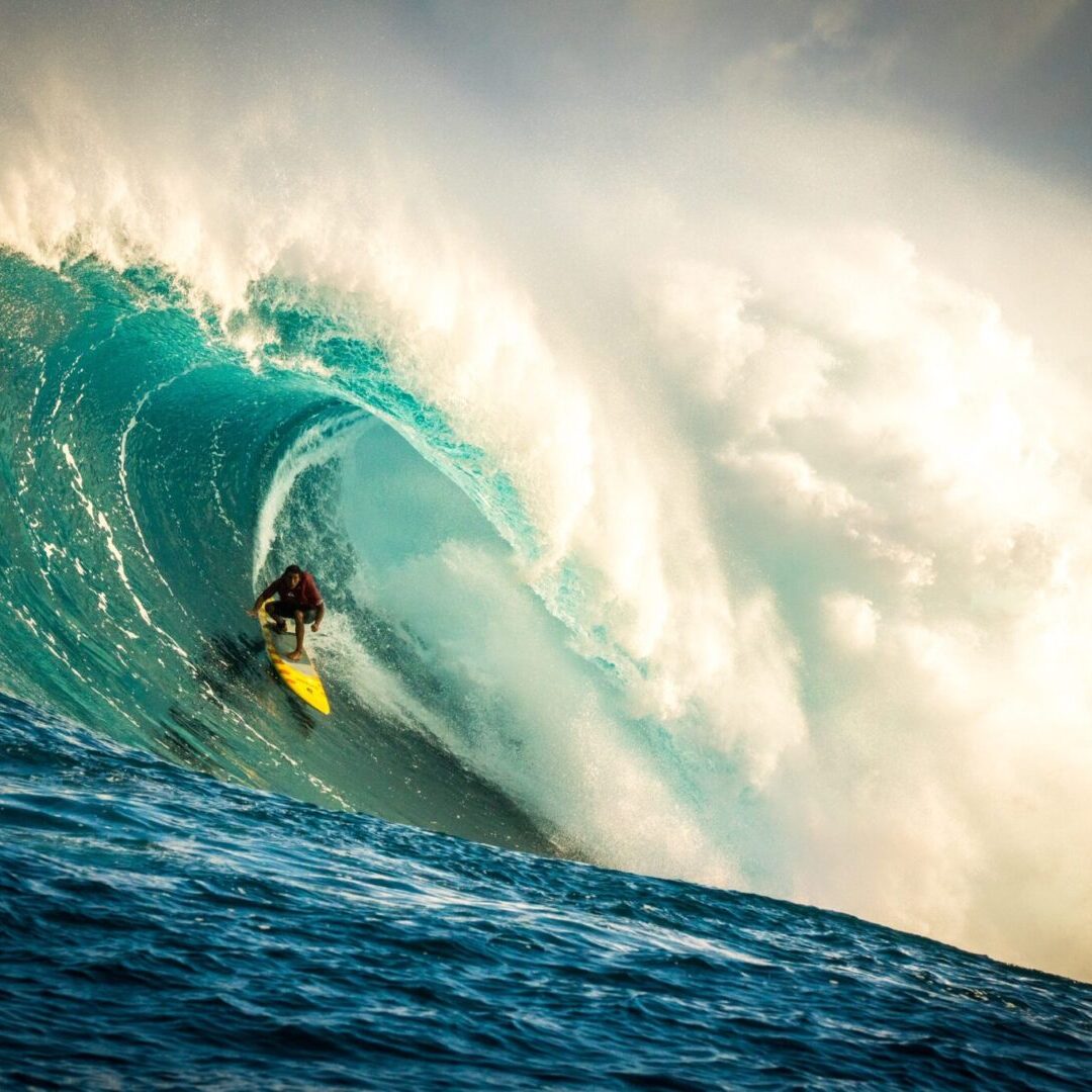 A person on a surfboard riding a wave.