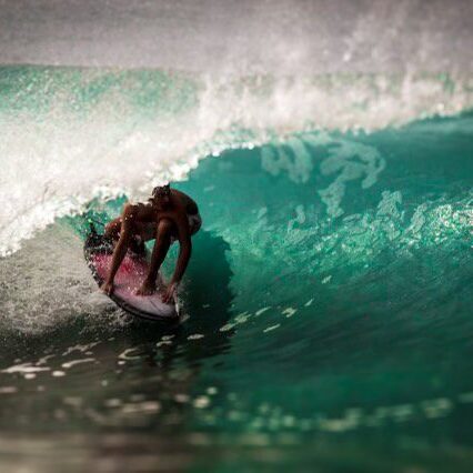 A person on a surfboard riding the waves.