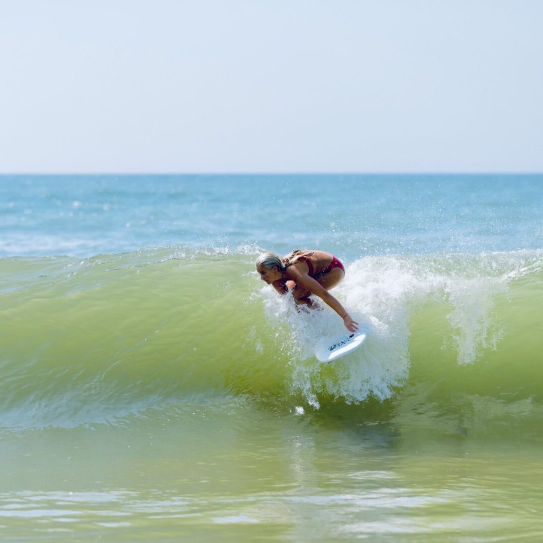 A person on a surfboard in the ocean.